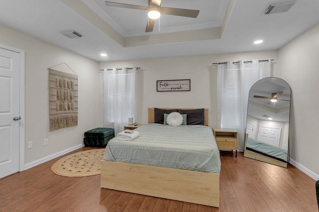 746 Cape Cottage Lane Spring, TX 77373 - Photo 4 of 36 a bedroom with a bed and a table with wooden floor