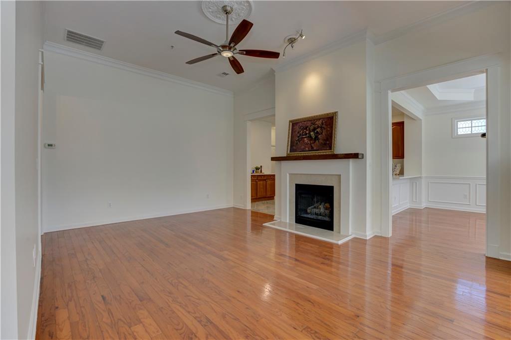 232 Glens Loop Woodstock, GA 30188 - Photo 12 of 52 a view of a livingroom with a fireplace a ceiling fan and wooden floor