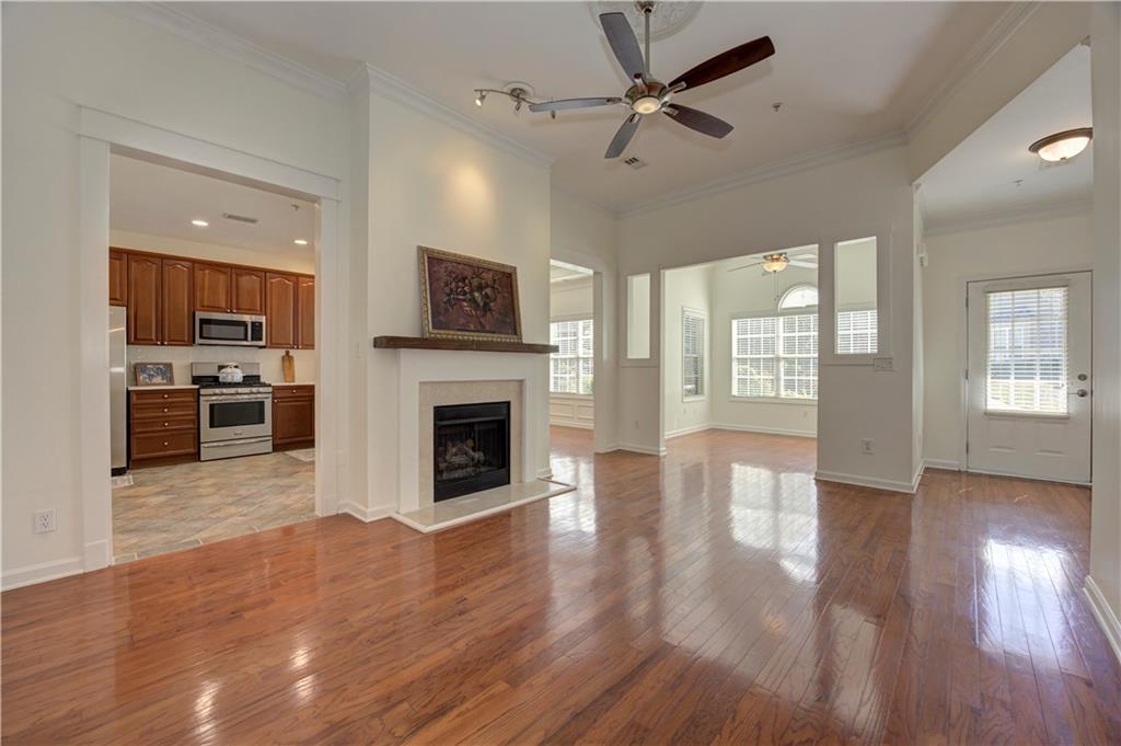 232 Glens Loop Woodstock, GA 30188 - Photo 14 of 52 a view of a livingroom with a fireplace a ceiling fan and wooden floor