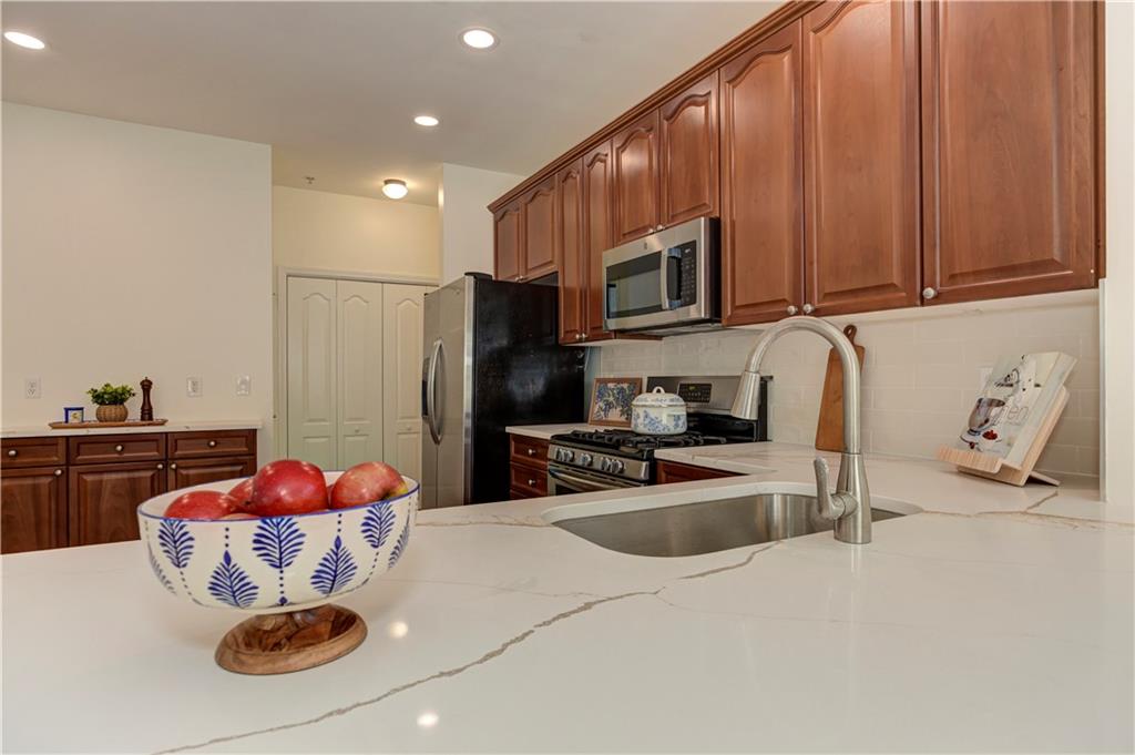 232 Glens Loop Woodstock, GA 30188 - Photo 23 of 52 a kitchen with stainless steel appliances granite countertop a sink refrigerator and cabinets