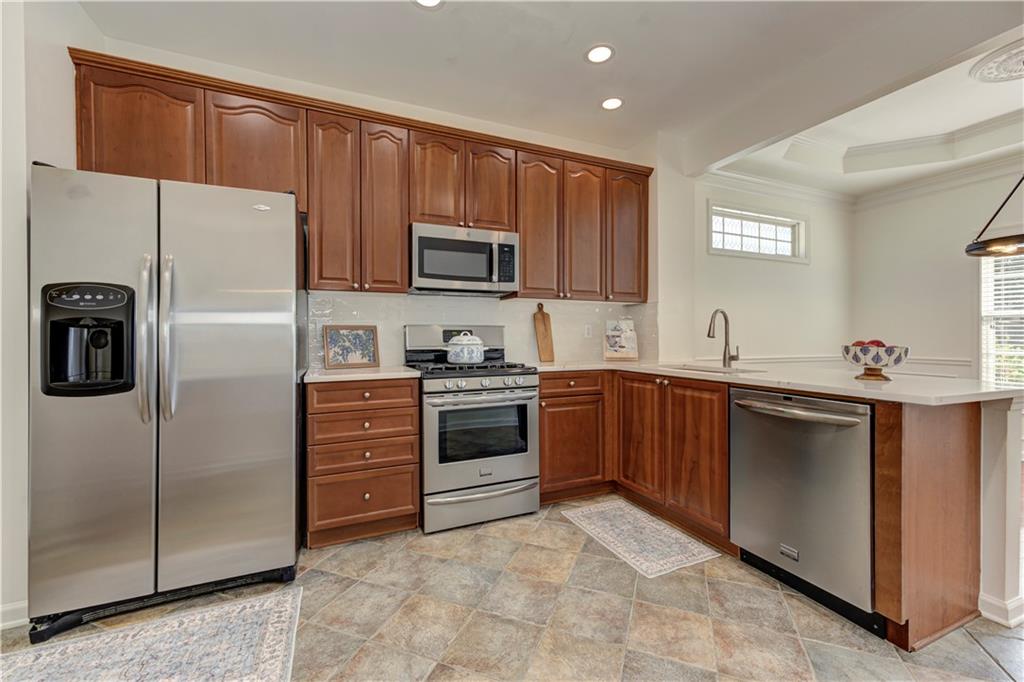 232 Glens Loop Woodstock, GA 30188 - Photo 24 of 52 a kitchen with stainless steel appliances a refrigerator sink and microwave