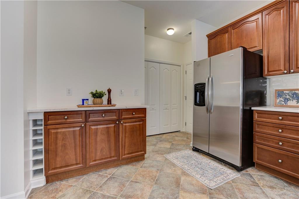 232 Glens Loop Woodstock, GA 30188 - Photo 27 of 52 a kitchen with stainless steel appliances a refrigerator and cabinets