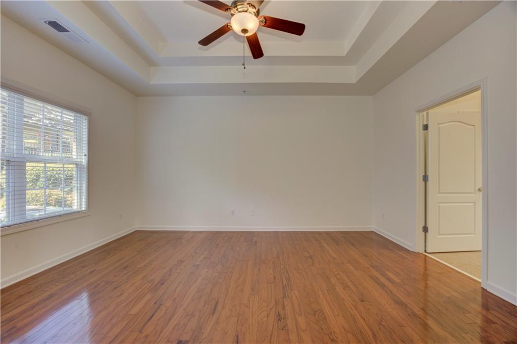 232 Glens Loop Woodstock, GA 30188 - Photo 33 of 52 wooden floor in an empty room with a window