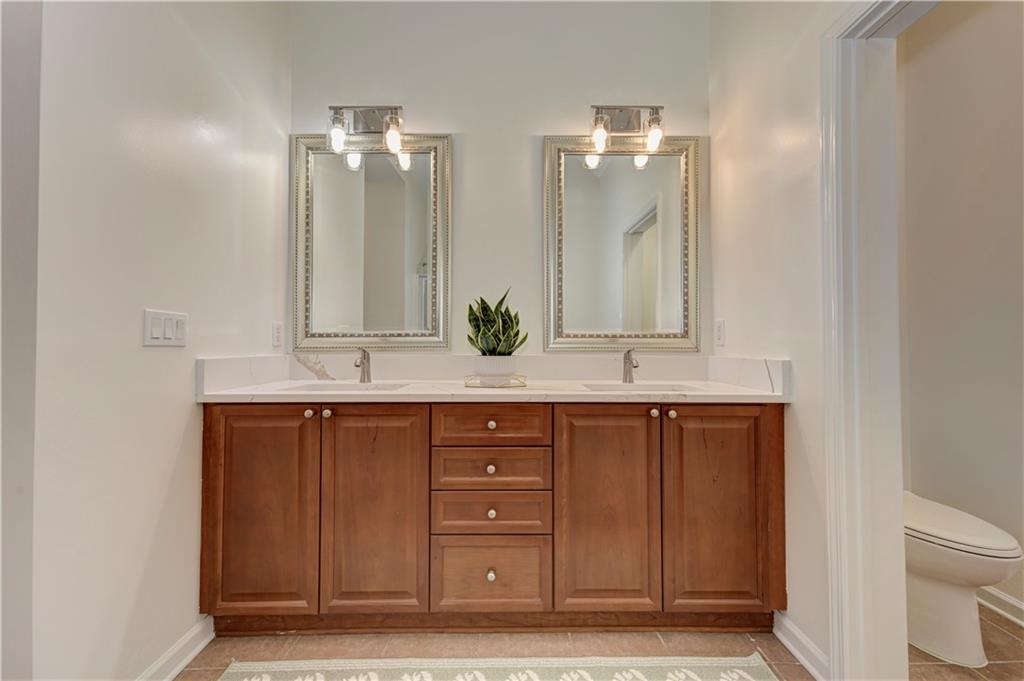 232 Glens Loop Woodstock, GA 30188 - Photo 39 of 52 a bathroom with a double vanity sink and mirror