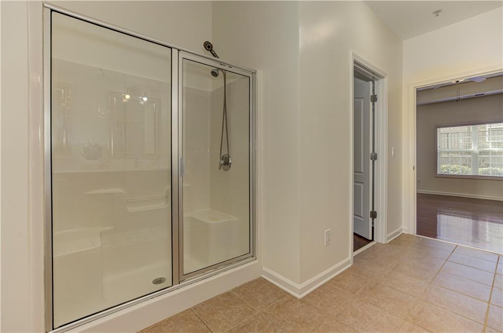 232 Glens Loop Woodstock, GA 30188 - Photo 41 of 52 a bathroom with a shower and a glass door