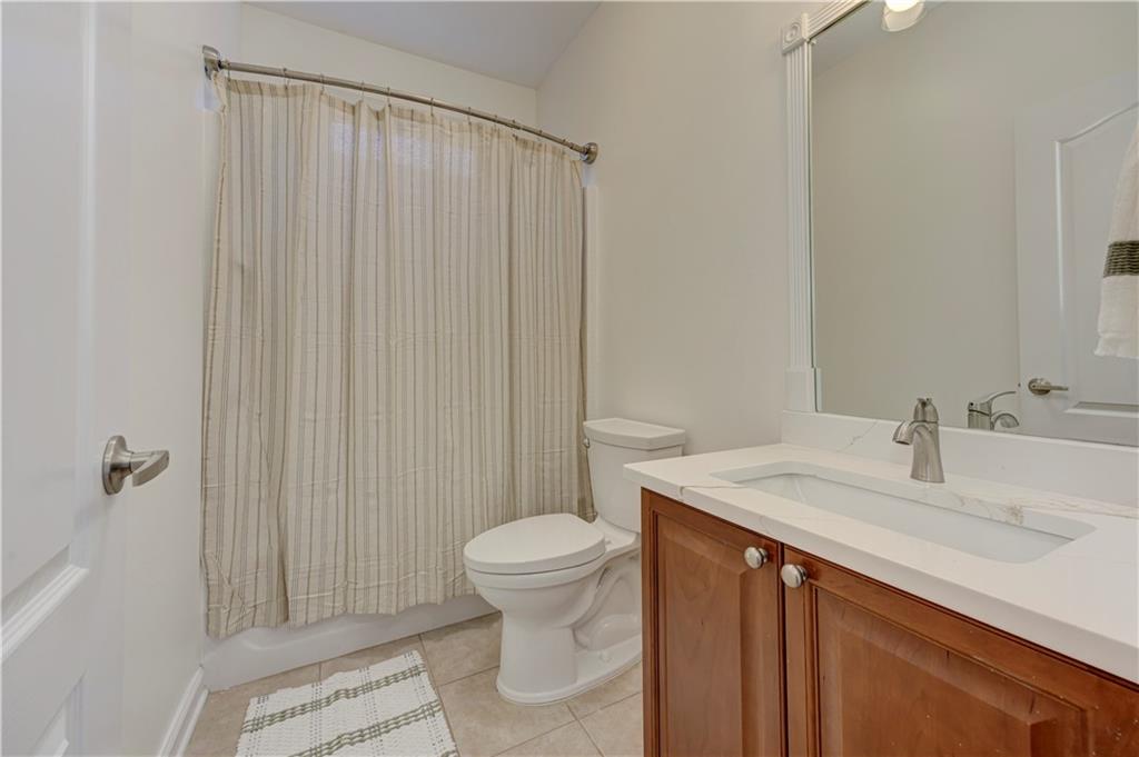 232 Glens Loop Woodstock, GA 30188 - Photo 46 of 52 a bathroom with a sink a toilet and shower