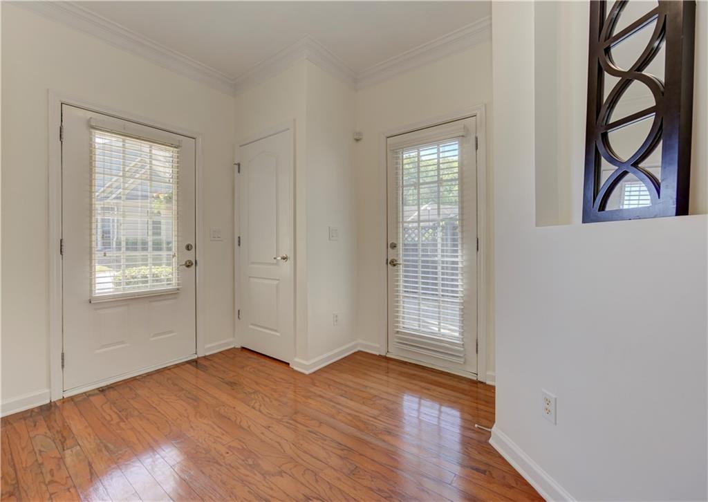 232 Glens Loop Woodstock, GA 30188 - Photo 10 of 52 an empty room with wooden floor and windows