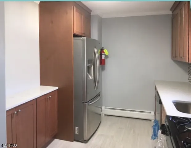 a kitchen with a refrigerator and cabinets