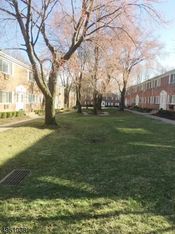 a backyard of apartments with large trees