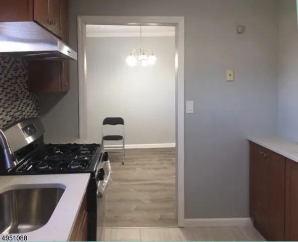 a kitchen with a sink and a stove top oven