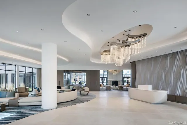 a living room with furniture and chandelier