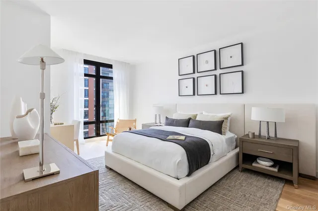 a bedroom with a bed a mirror and a window