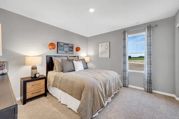 a bedroom with a bed and a lamp