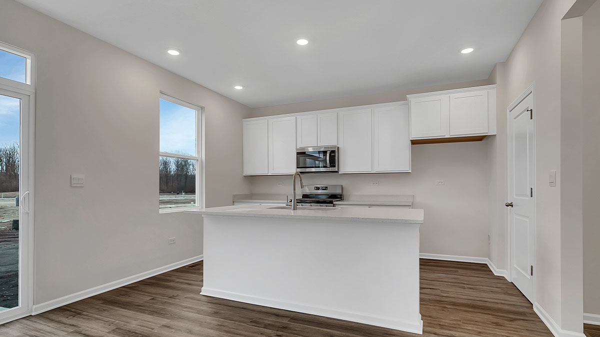 26110 South Castle Boulevard Manhattan, IL 60442 - Photo 6 of 30 a kitchen with stainless steel appliances granite countertop a sink a stove and a refrigerator