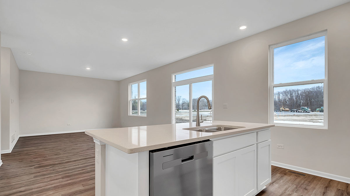26110 South Castle Boulevard Manhattan, IL 60442 - Photo 10 of 30 a kitchen with granite countertop cabinets stainless steel appliances and a wooden floor