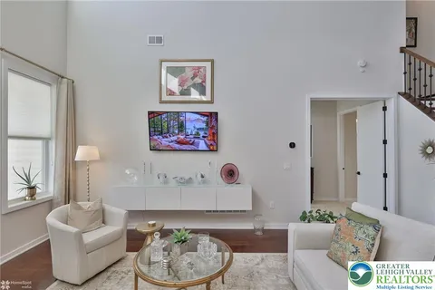 a living room with a book shelf and a book shelf