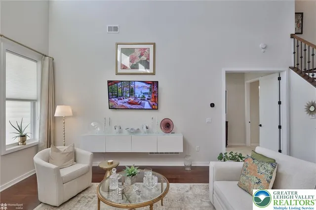 a living room with a book shelf and a book shelf