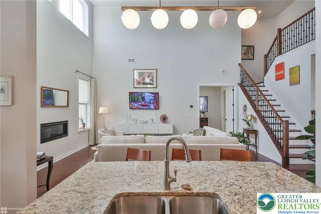 an aerial view of a house with a swimming pool outdoor seating and yard