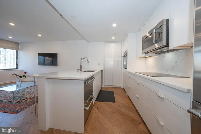 a kitchen with refrigerator and cabinets