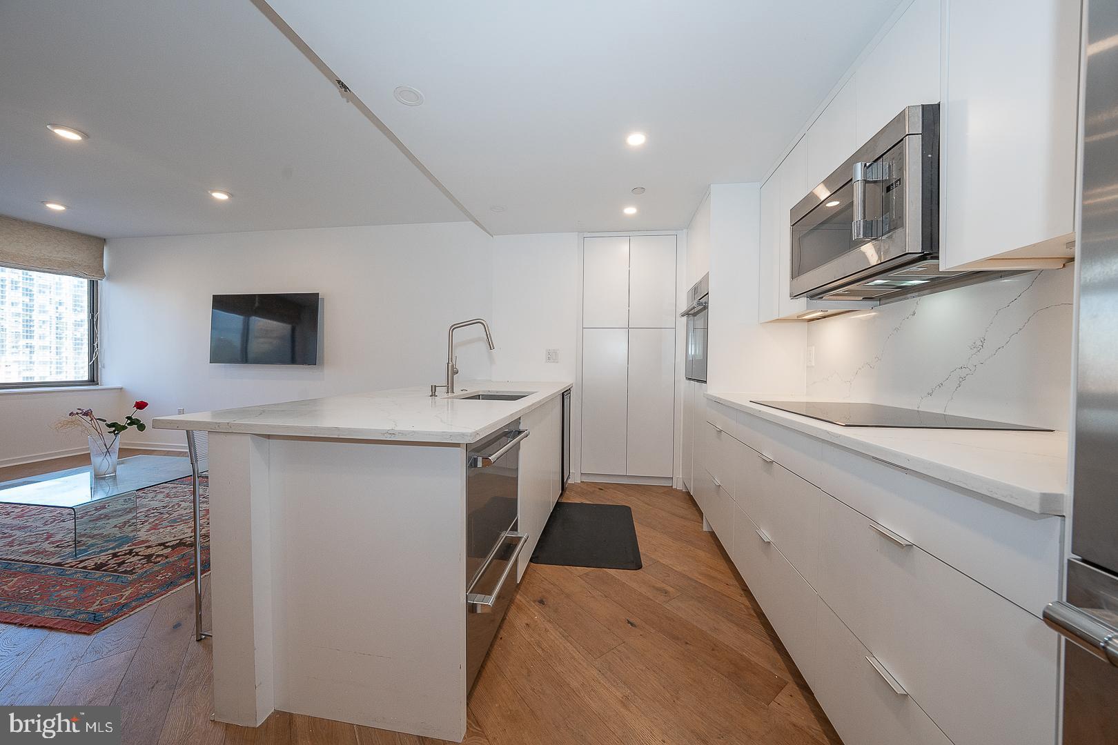 202-10 West Rittenhouse Square, Unit 1205 Philadelphia, PA 19103 - Photo 11 of 28 a kitchen with refrigerator and cabinets