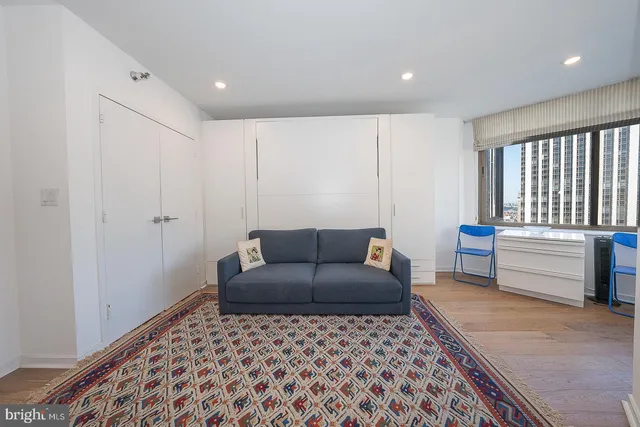 a living room with a couch and a rug