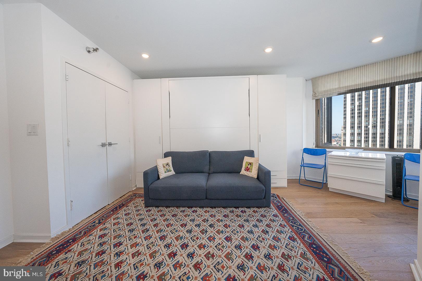 202-10 West Rittenhouse Square, Unit 1205 Philadelphia, PA 19103 - Photo 14 of 28 a living room with a couch and a dresser