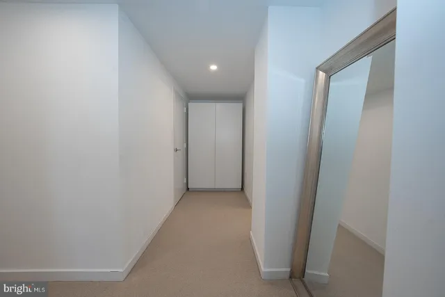 a view of walk in closet with empty racks