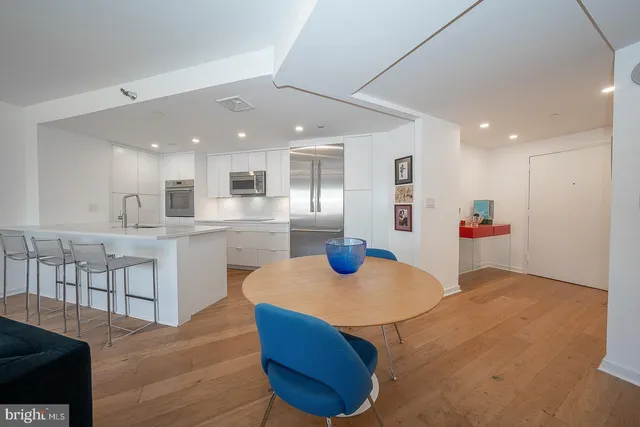 a kitchen with stainless steel appliances kitchen island granite countertop a sink and cabinets