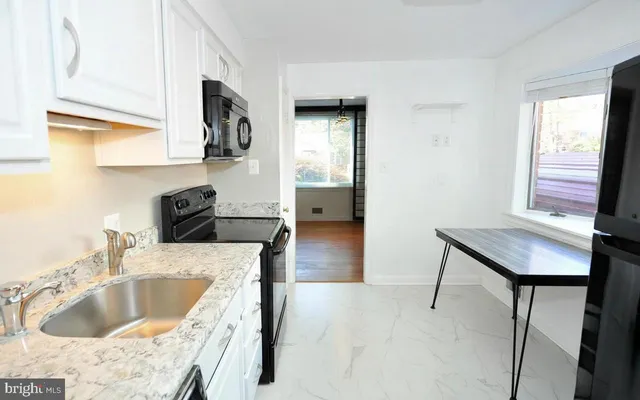 a kitchen with a sink cabinets and window