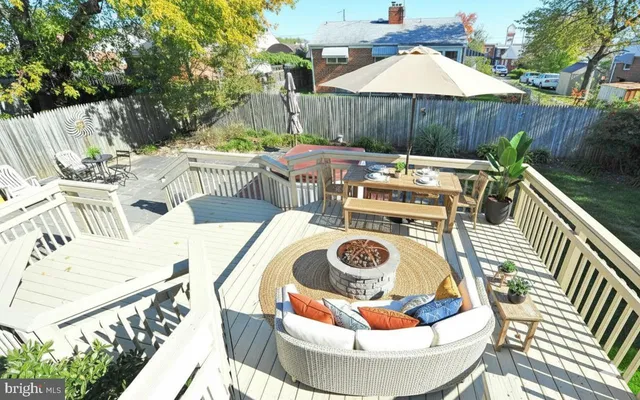 a view of a patio with table and chairs potted plants with wooden floor