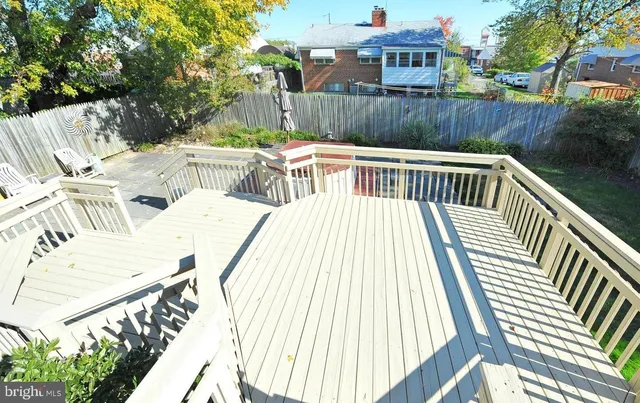 a view of balcony with wooden floor and outdoor seating