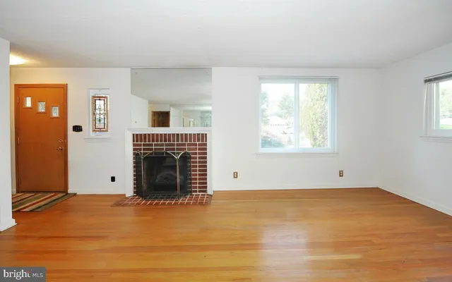 a view of empty room with window and fireplace