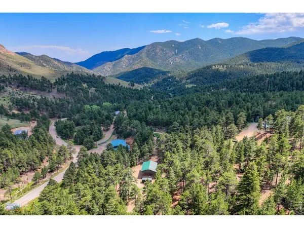 a view of a lush green hillside and a building