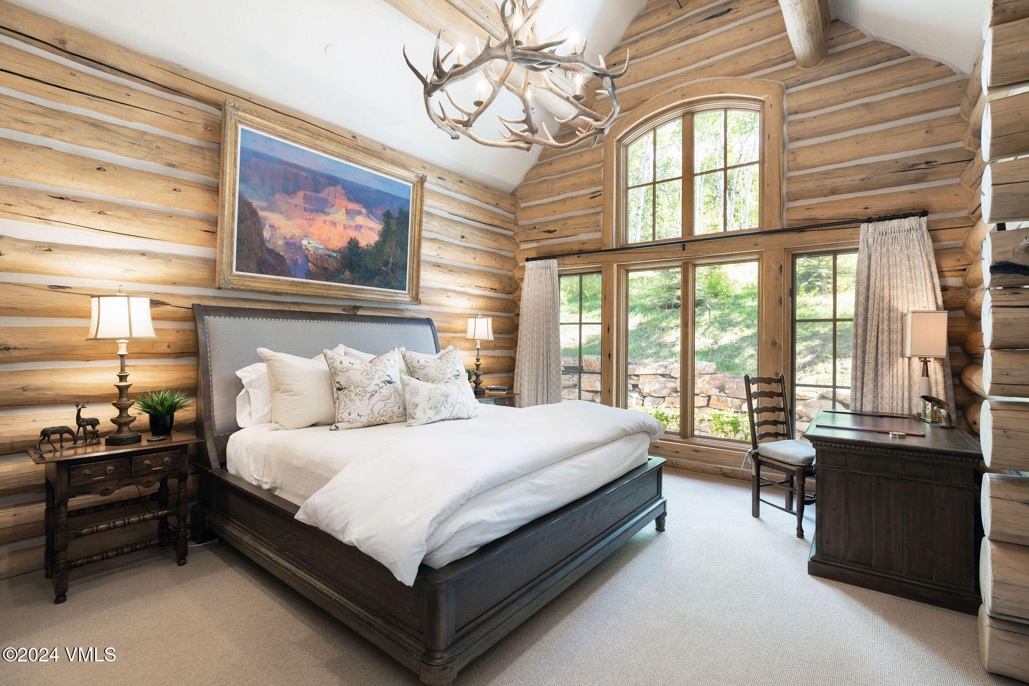 57 Travis Road Wolcott, CO 81655 - Photo 16 of 26 a bedroom with a bed and a chandelier