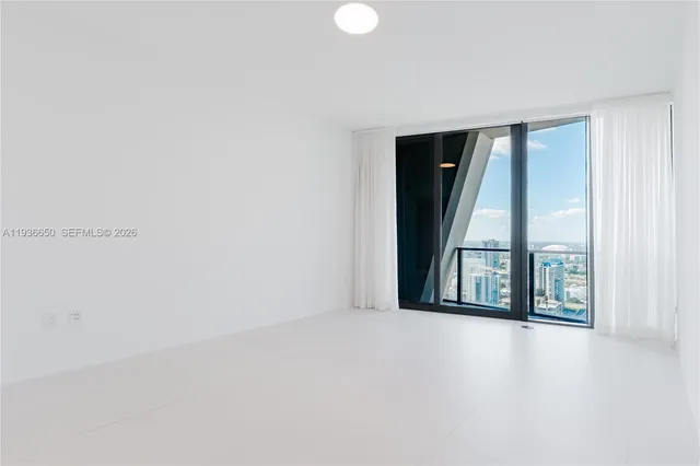 an empty room with windows and closet