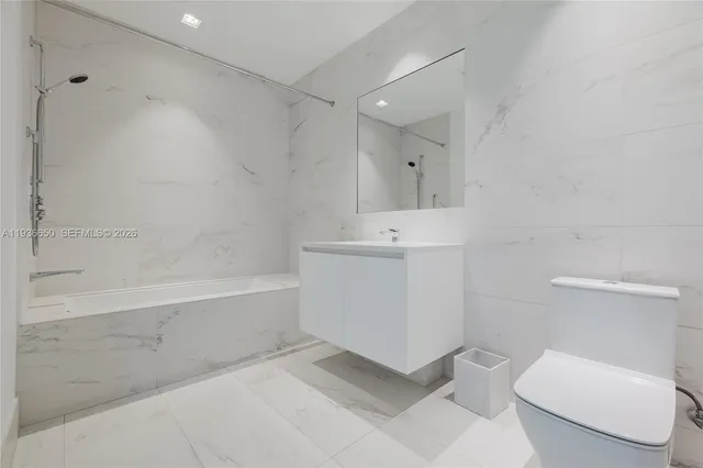 a bathroom with a toilet sink and bathtub