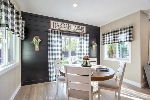 a dining room with furniture a chandelier and wooden floor