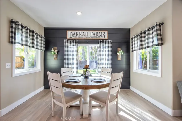 a kitchen with stainless steel appliances kitchen island granite countertop a table and chairs