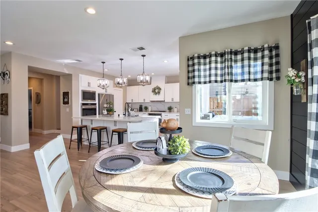 a very nice looking room with a large window and wooden floor