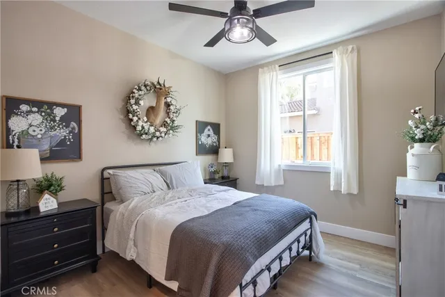 a bed room with a bed a television and a large window