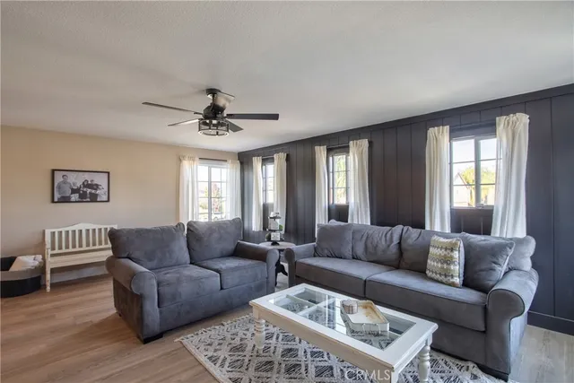 a view of a workspace with furniture and wooden floor