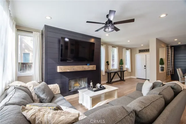 a living room with furniture a fireplace and a flat screen tv