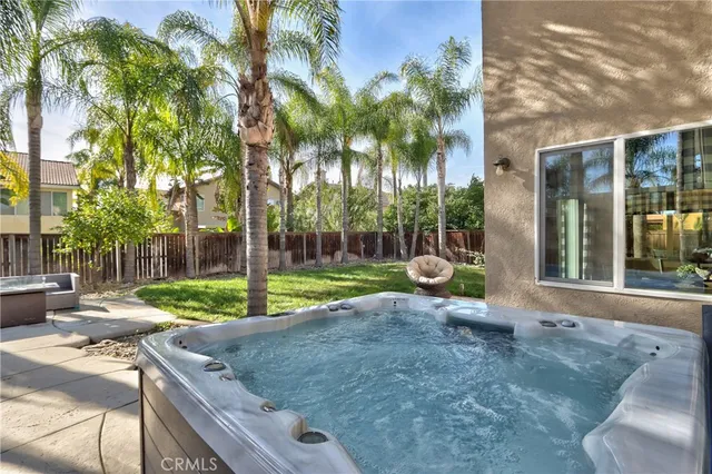 a view of a tree in a backyard of a house