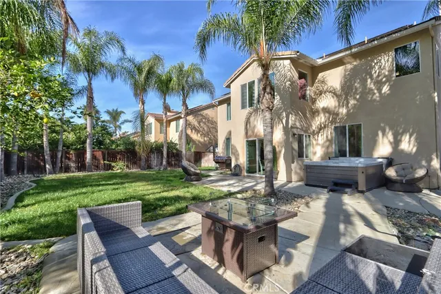 a view of patio with a table and chairs under an umbrella