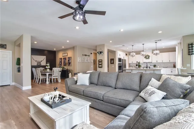 a living room with furniture kitchen view and a table