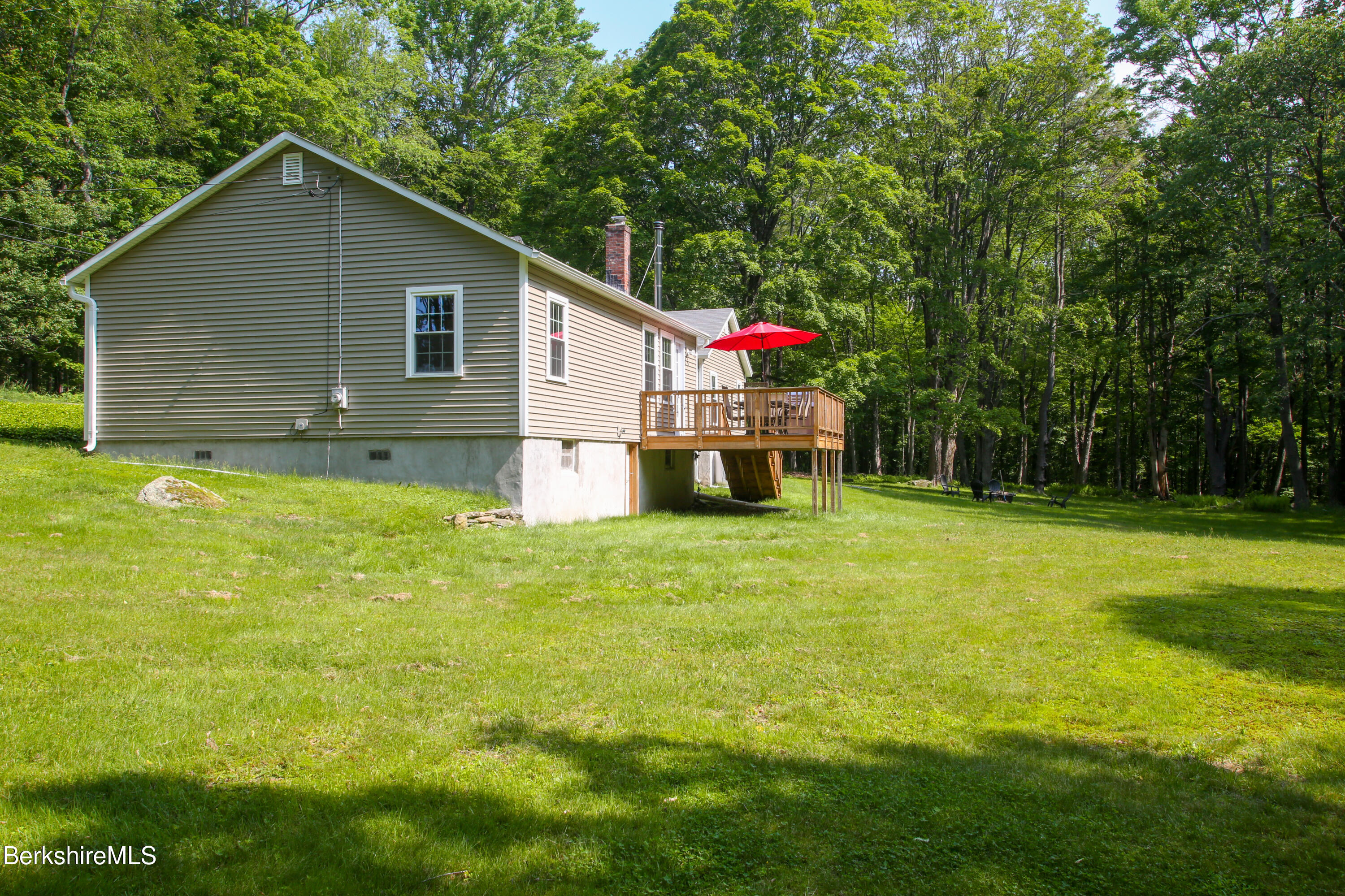 127 County Road Rowe, MA 01367 - Photo 28 of 29 a backyard of a house with table and chairs