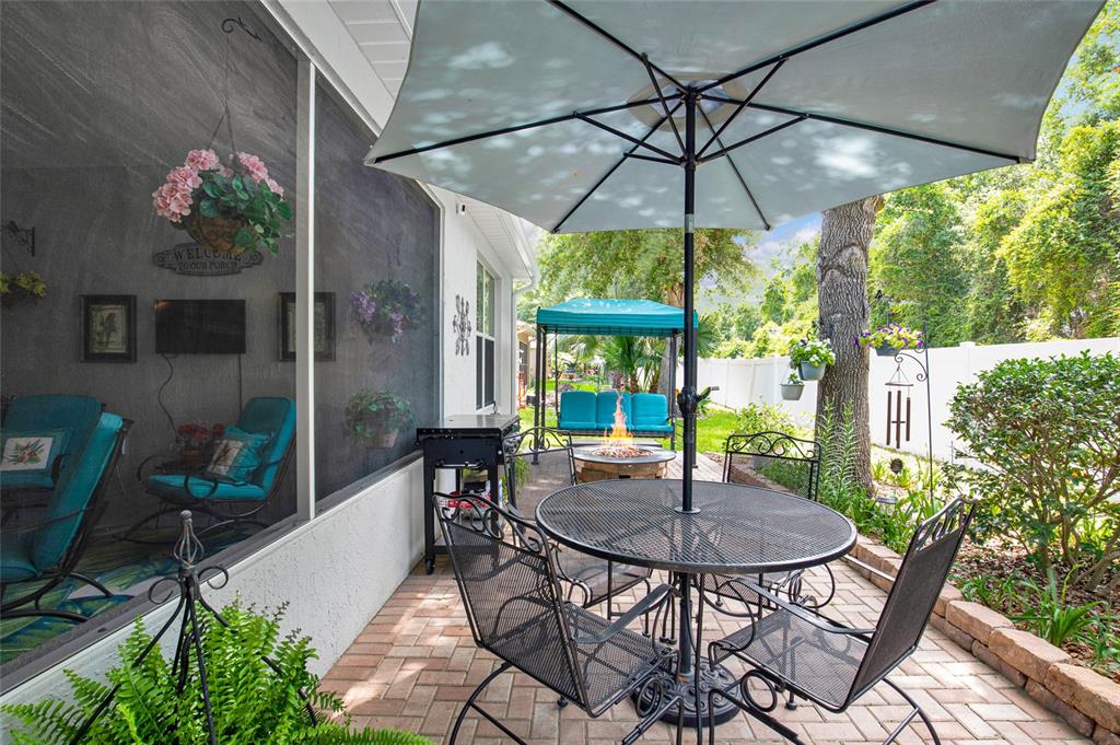 16411 Southwest 14th Avenue Road Ocala, FL 34473 - Photo 41 of 59 a patio with a yard table and chairs