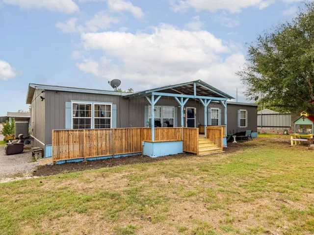 a view of a house with swimming pool and sitting area