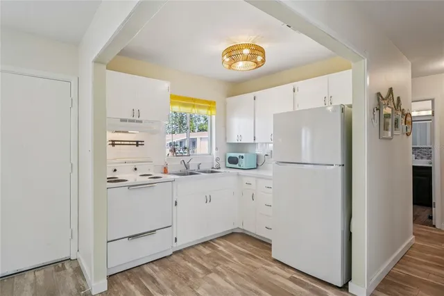 a white refrigerator freezer sitting inside of a kitchen