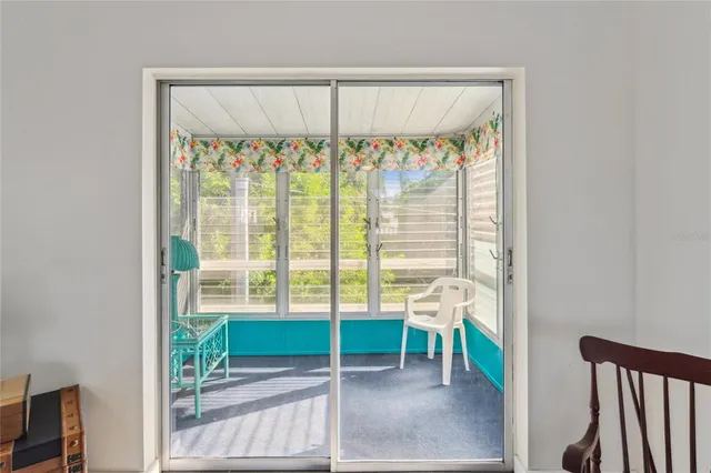 a view of a porch with a table and chairs